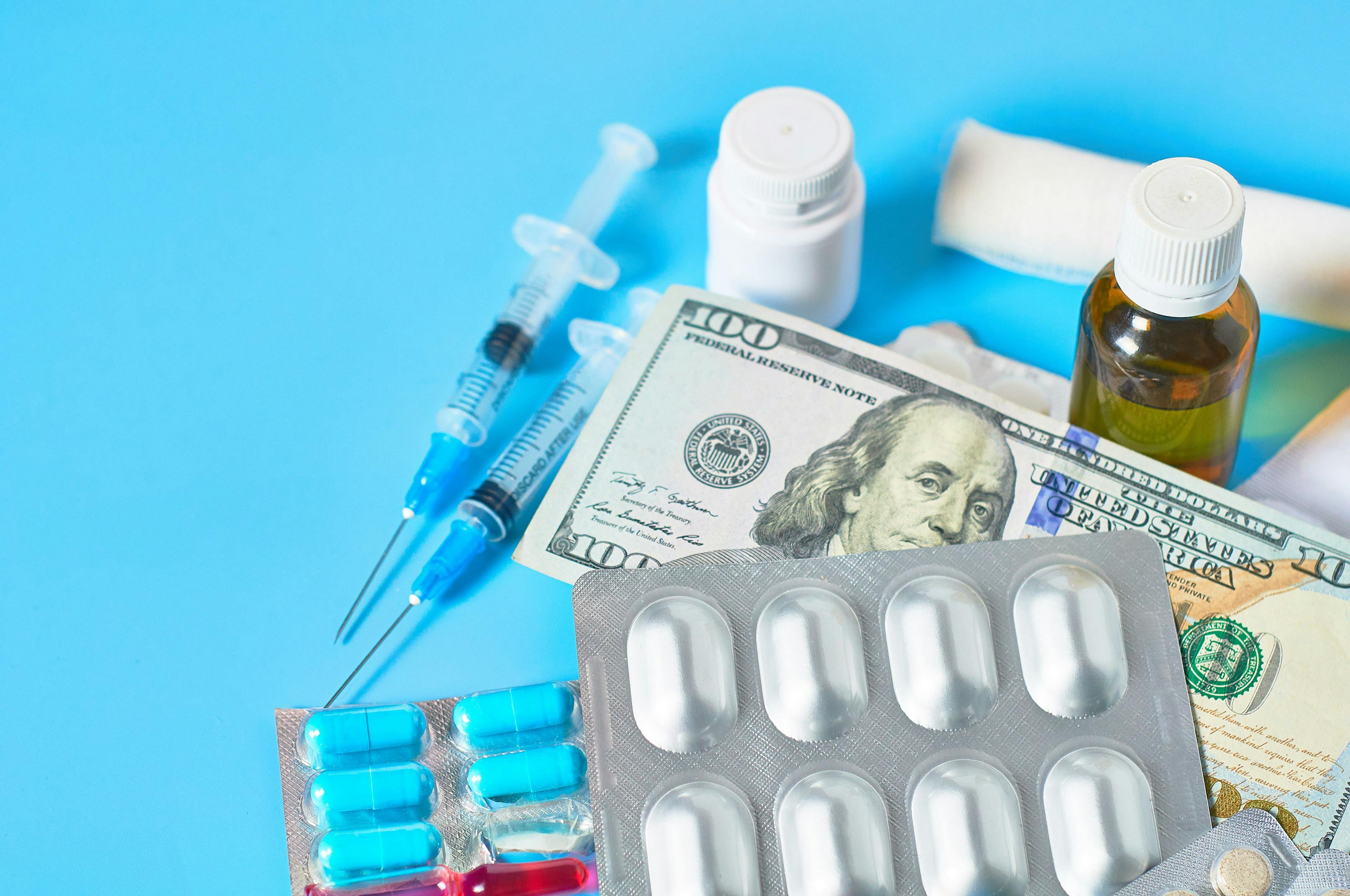 Photo illustration of medications with $100 bills | Image credit: © olekstock  stock.adobe.com