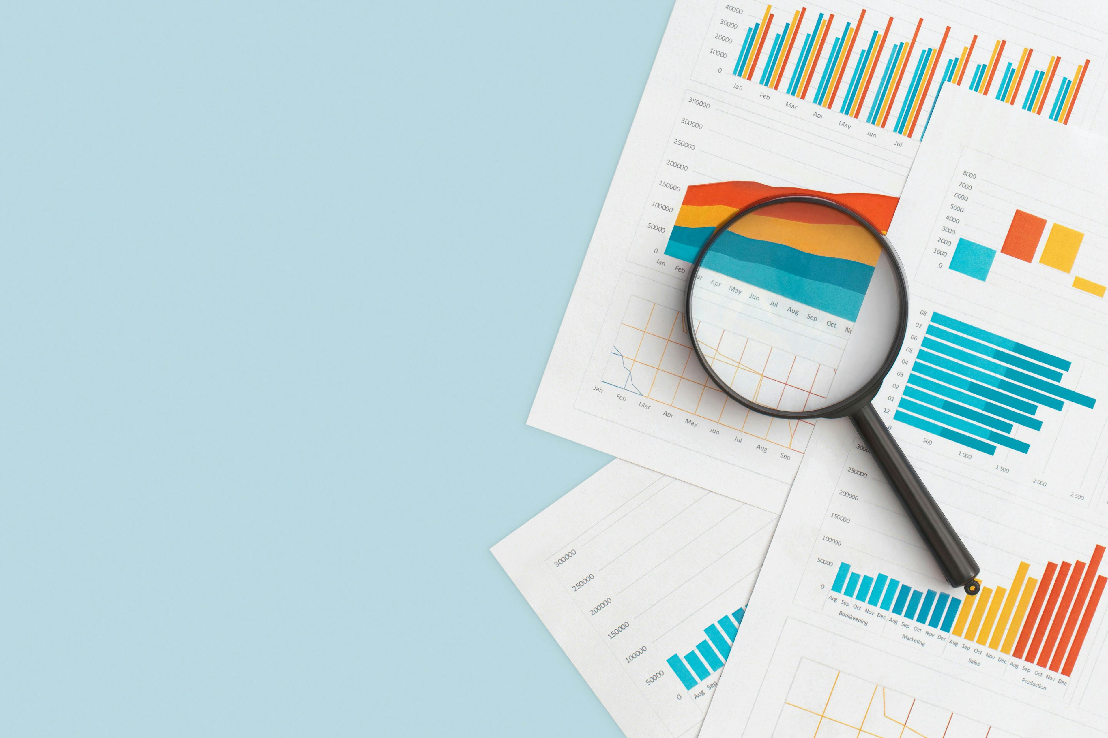 magnifying glass and charts | Image credit: Lunakate   stock.adobe.com