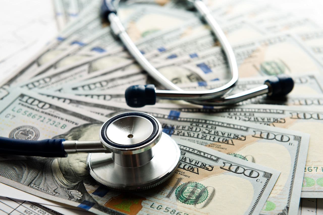 Stethoscope on 100 dollar bills | Image credit: Valeri Luzina - stock.adobe.com